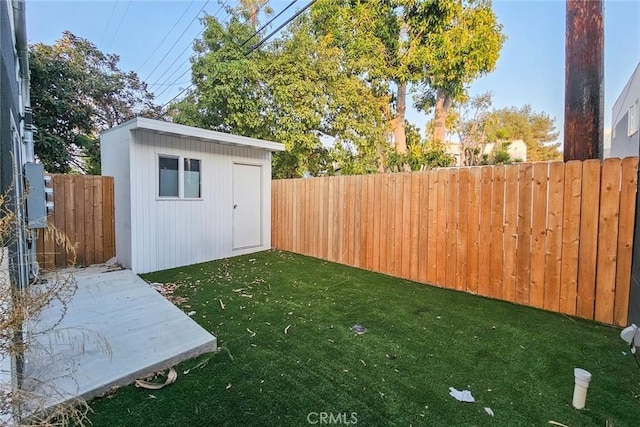 view of yard featuring a shed and a patio