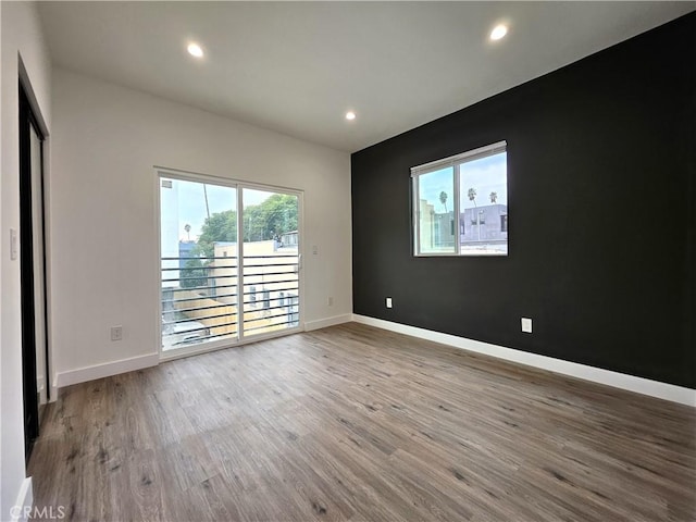 unfurnished room with light hardwood / wood-style floors