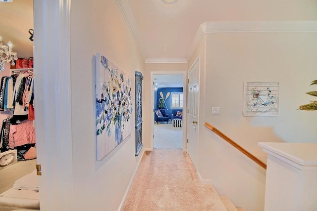 hall featuring ornamental molding and light colored carpet