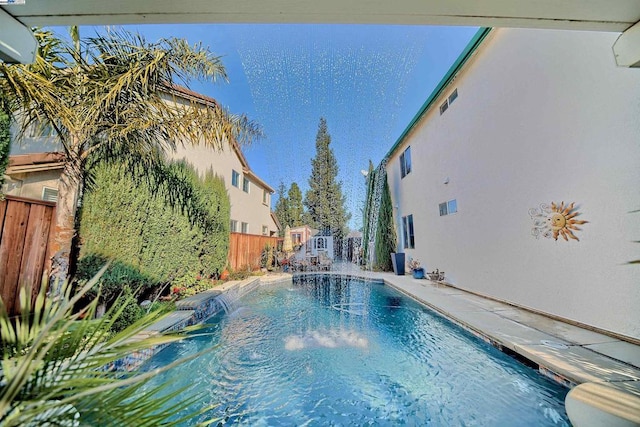 view of swimming pool with pool water feature