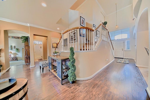 interior space with hardwood / wood-style floors, crown molding, and a healthy amount of sunlight