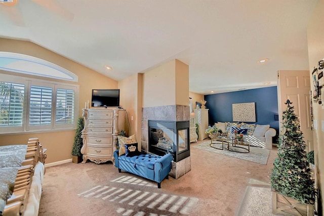 carpeted living room featuring lofted ceiling and a tile fireplace