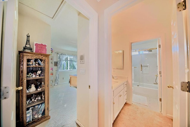 hallway featuring light colored carpet