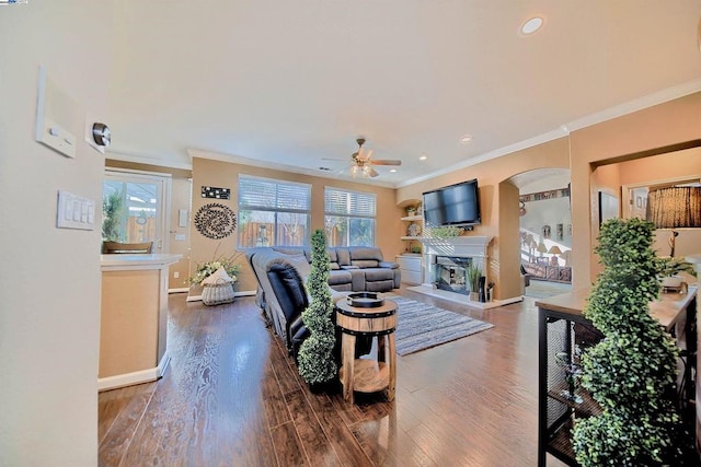 living room with ornamental molding, plenty of natural light, and dark hardwood / wood-style floors