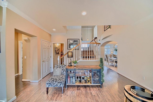 hall featuring ornamental molding and hardwood / wood-style floors