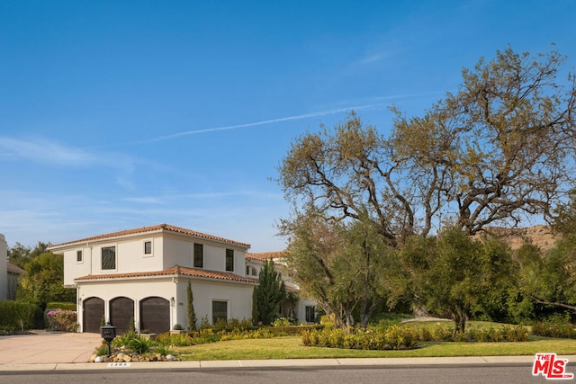 mediterranean / spanish house featuring a garage