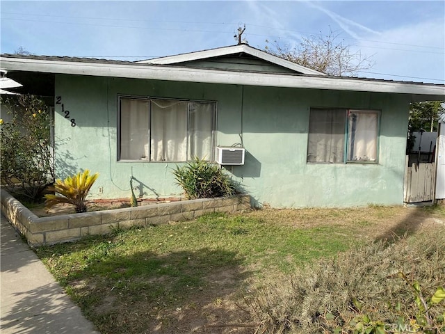 view of side of property featuring a yard and cooling unit