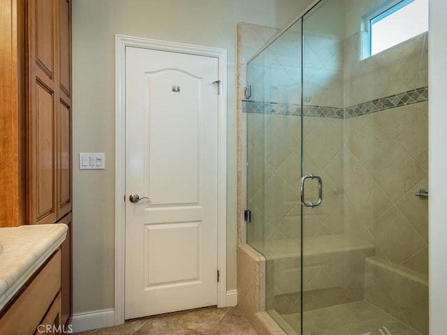 bathroom featuring an enclosed shower, vanity, and tile patterned floors