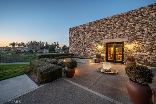 view of patio terrace at dusk