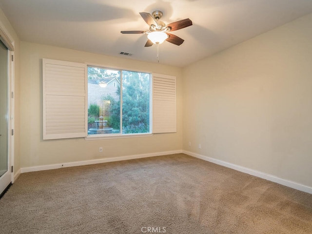 empty room featuring ceiling fan and carpet flooring