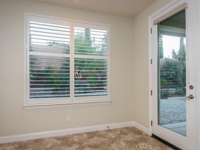 doorway to outside with plenty of natural light and light tile patterned flooring