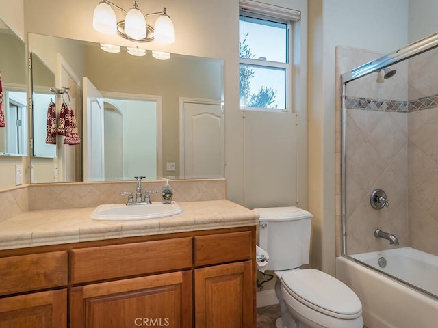 full bathroom featuring toilet, vanity, and shower / bath combination with glass door