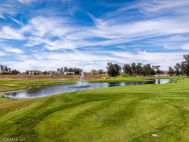 view of community with a yard and a water view