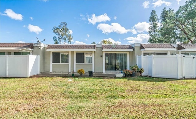 rear view of property featuring a yard