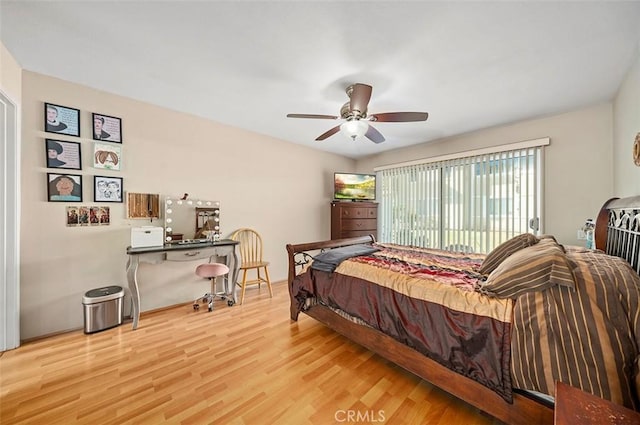 bedroom with hardwood / wood-style flooring, access to outside, and ceiling fan