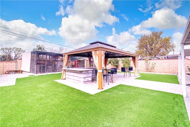 view of yard featuring a gazebo, a patio, and a storage shed