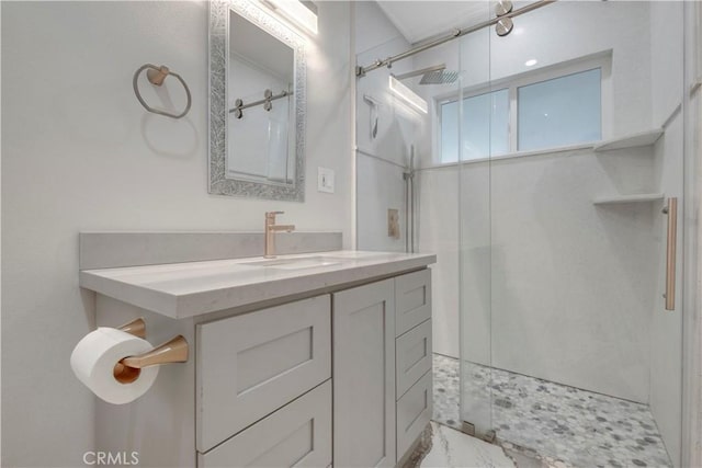 bathroom featuring vanity and a shower with shower door