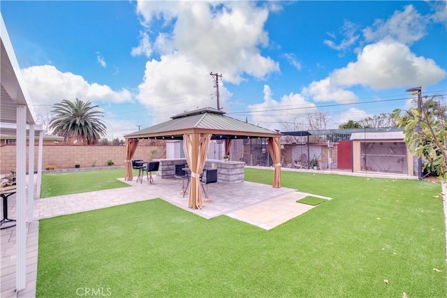 view of yard featuring a shed, a gazebo, and a patio area