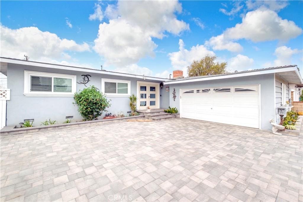 ranch-style house featuring a garage