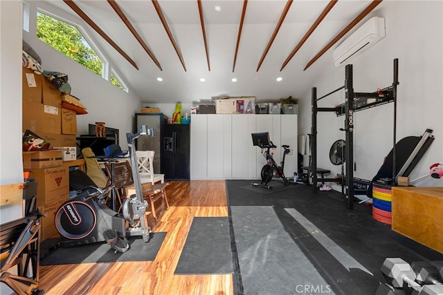 workout area with hardwood / wood-style flooring, a wall mounted AC, and high vaulted ceiling