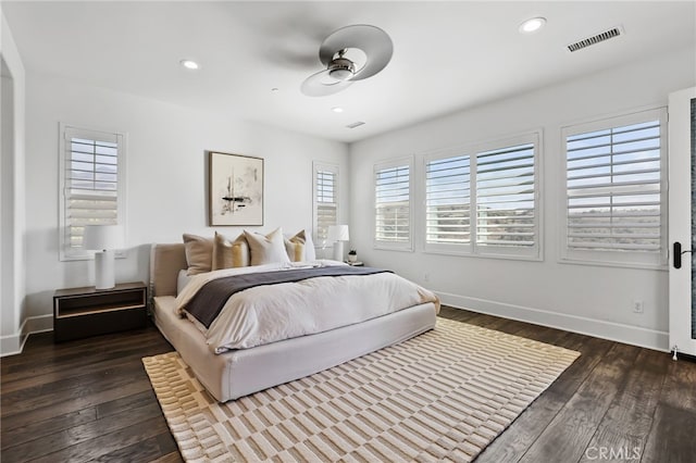 bedroom with dark hardwood / wood-style flooring