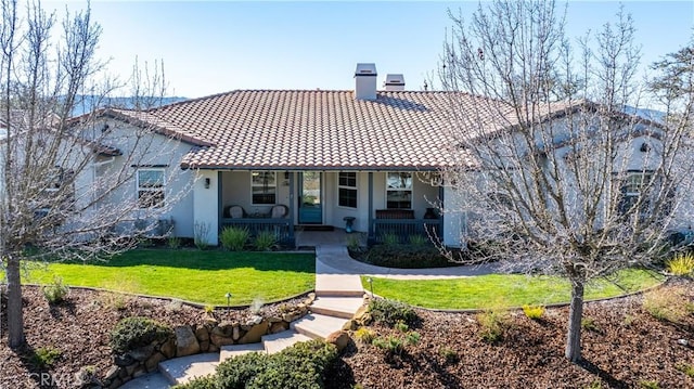 view of front of property featuring a front lawn and covered porch