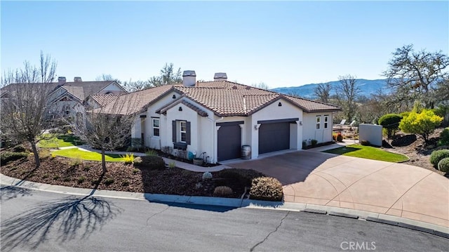 view of front of house with a mountain view and a garage