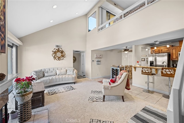 tiled living room with high vaulted ceiling and ceiling fan