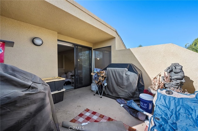 view of patio featuring area for grilling and a balcony