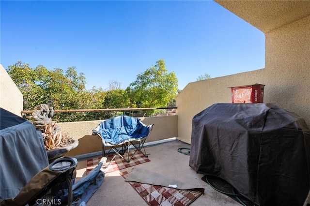 view of patio featuring a grill and a balcony