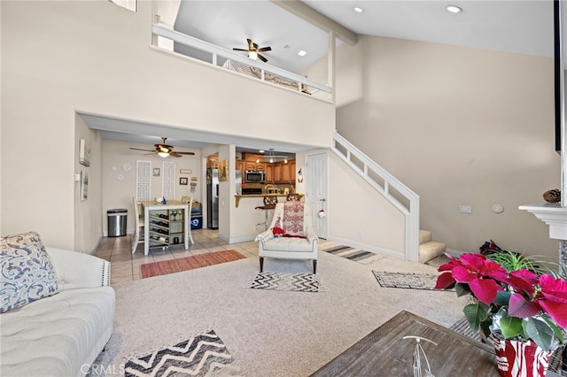 living room featuring beamed ceiling, ceiling fan, and high vaulted ceiling