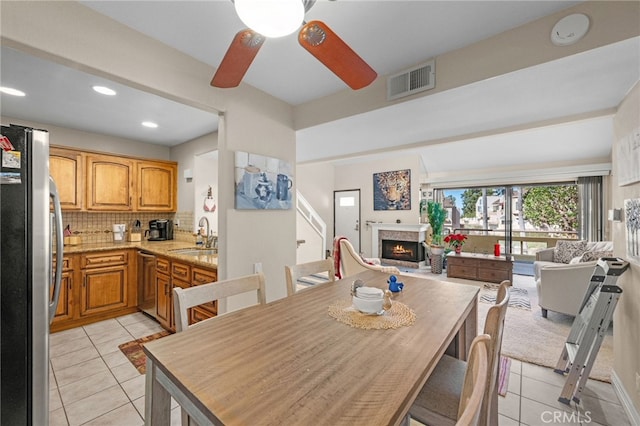 tiled dining room with sink and ceiling fan