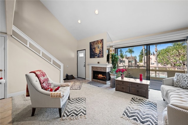 living room with light carpet and high vaulted ceiling