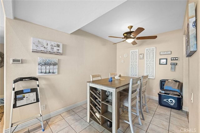 tiled dining space featuring ceiling fan