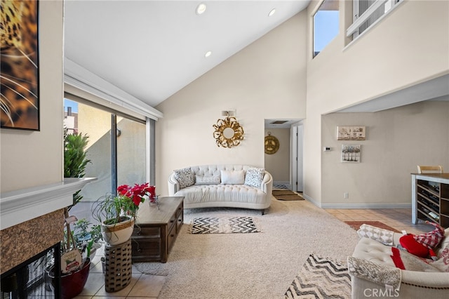 living room featuring light tile patterned floors, a fireplace, and high vaulted ceiling