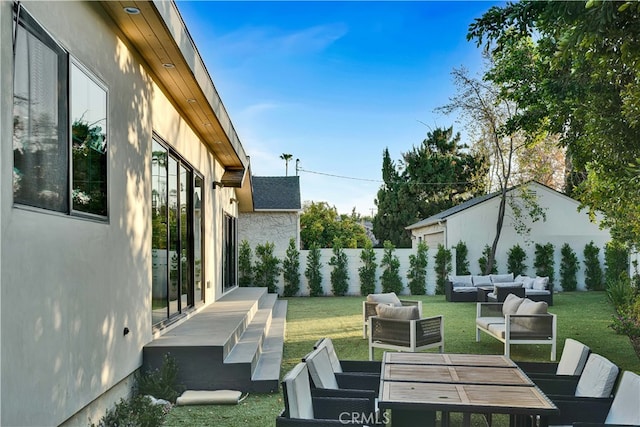 view of yard with an outdoor living space and a patio area