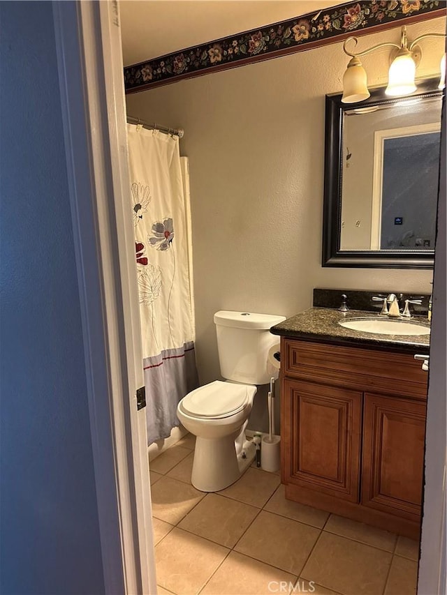 bathroom with vanity, tile patterned floors, and toilet