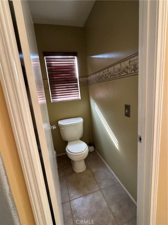 bathroom featuring tile patterned floors and toilet