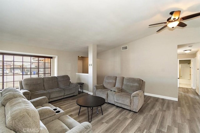 living room featuring lofted ceiling, hardwood / wood-style floors, and ceiling fan