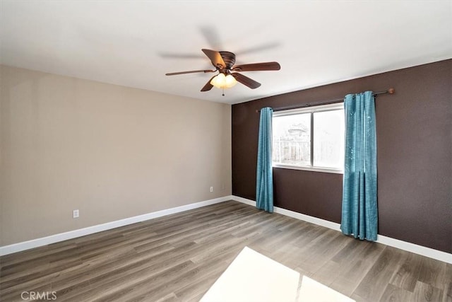 empty room featuring wood-type flooring and ceiling fan