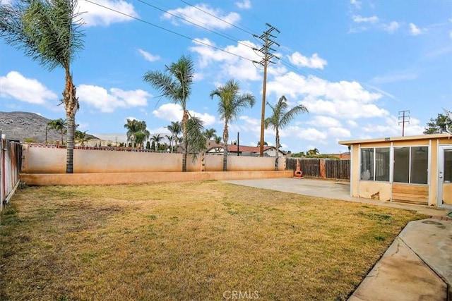 view of yard featuring a sunroom and a patio area