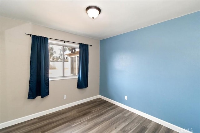 empty room with dark hardwood / wood-style floors