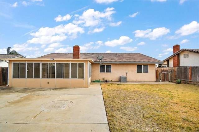 rear view of house with a sunroom, a lawn, a patio, and central air condition unit