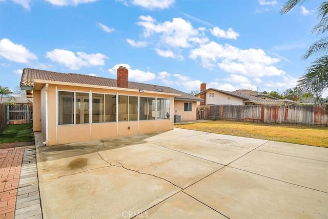 back of house featuring a sunroom, a yard, and a patio area