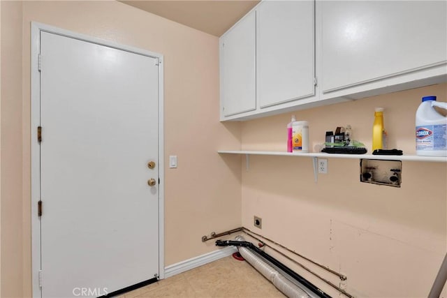 laundry area featuring hookup for an electric dryer, cabinet space, hookup for a washing machine, and baseboards