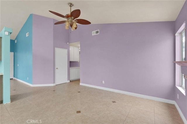 spare room featuring high vaulted ceiling, baseboards, a ceiling fan, and visible vents