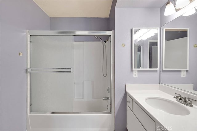bathroom with vanity and bath / shower combo with glass door