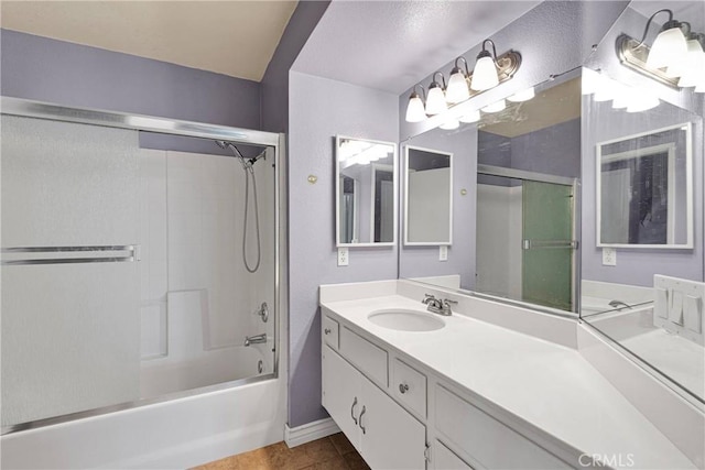 bathroom with enclosed tub / shower combo, baseboards, vanity, and tile patterned floors
