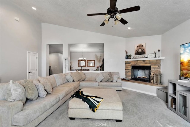 carpeted living area with a fireplace, lofted ceiling, a textured ceiling, baseboards, and ceiling fan with notable chandelier