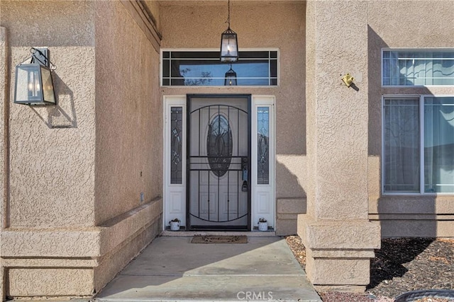 entrance to property featuring stucco siding